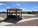 Outdoor gazebo with comfortable seating, gravel landscaping and a view of a sand volleyball court at 4193 W Warm Springs Rd, Las Vegas, NV 89118