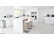 Bright kitchen features an island, modern appliances, and white cabinets at 4193 W Warm Springs Rd, Las Vegas, NV 89118