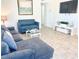 Bright living room showcasing tile floors, blue sofas, modern decor, and wall-mounted TV at 4193 W Warm Springs Rd, Las Vegas, NV 89118
