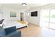 Spacious main bedroom featuring a large bed, a comfortable blue chair, and private balcony access at 4193 W Warm Springs Rd, Las Vegas, NV 89118