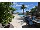 Backyard with a pristine pool, lounge chairs, and a fire pit, perfect for outdoor relaxation and entertainment at 4193 W Warm Springs Rd, Las Vegas, NV 89118