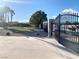 Putting green area featuring gated entrance and mature landscaping at 4193 W Warm Springs Rd, Las Vegas, NV 89118