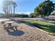 Backyard putting green area featuring a picnic table and benches at 4193 W Warm Springs Rd, Las Vegas, NV 89118