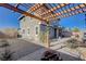 Relaxing backyard with gravel landscaping, a pergola, and a cozy fire pit area for outdoor enjoyment at 422 Barcarolle Ln, Henderson, NV 89011