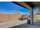 Private backyard featuring a stone-paved patio, brick privacy wall, and a barrel accent at 422 Barcarolle Ln, Henderson, NV 89011