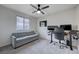 This bedroom is a versatile space, featuring a gray sofa bed and a dedicated computer desk area at 422 Barcarolle Ln, Henderson, NV 89011