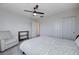 Bright bedroom featuring a ceiling fan, carpeted floors, and ample closet space, perfect for relaxation and storage at 422 Barcarolle Ln, Henderson, NV 89011