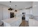 Bright, modern kitchen with stainless steel appliances, quartz countertops, large island, and light wood flooring at 422 Barcarolle Ln, Henderson, NV 89011