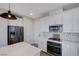 Well-equipped kitchen featuring white cabinets, stainless appliances, and ample counter space at 422 Barcarolle Ln, Henderson, NV 89011