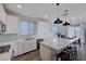 Stylish kitchen with stainless appliances, white cabinets, and island seating at 422 Barcarolle Ln, Henderson, NV 89011