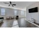 Bright living room featuring neutral walls, tile floors, and a modern ceiling fan at 422 Barcarolle Ln, Henderson, NV 89011