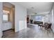 Open-concept living space with ample natural light and wood-look flooring, adjacent to a convenient half-bathroom at 422 Barcarolle Ln, Henderson, NV 89011