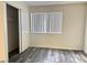 Bright bedroom with gray vinyl flooring and a large closet at 5002 S Rainbow Blvd # 106, Las Vegas, NV 89118