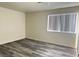Well-lit bedroom featuring gray vinyl flooring and a large window at 5002 S Rainbow Blvd # 106, Las Vegas, NV 89118