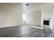 Spacious living room with gray vinyl flooring and a modern fireplace at 5002 S Rainbow Blvd # 106, Las Vegas, NV 89118