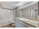 Well-lit bathroom featuring a shower-tub combo and a vanity with a granite-style countertop at 555 E Silverado Ranch Blvd # 2086, Las Vegas, NV 89183