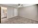 Neutral carpeted bedroom with ceiling fan and doors leading to bathroom and hallway at 555 E Silverado Ranch Blvd # 2086, Las Vegas, NV 89183