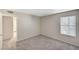 Neutral bedroom featuring plush carpeting, a window with blinds, and an ensuite bathroom at 555 E Silverado Ranch Blvd # 2086, Las Vegas, NV 89183