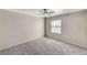 Carpeted bedroom featuring a ceiling fan, a window with blinds, and neutral wall paint at 555 E Silverado Ranch Blvd # 2086, Las Vegas, NV 89183