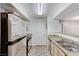 Efficient kitchen featuring stainless steel appliances, dual sinks, and tan countertops at 555 E Silverado Ranch Blvd # 2086, Las Vegas, NV 89183