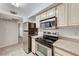 Modern kitchen with stainless steel appliances, light wood cabinets, and granite countertops at 555 E Silverado Ranch Blvd # 2086, Las Vegas, NV 89183