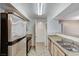 Efficient kitchen featuring stainless steel appliances, dual sinks, and tan countertops at 555 E Silverado Ranch Blvd # 2086, Las Vegas, NV 89183