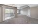 Bright living room with sliding glass doors to balcony, neutral tones, and new carpet at 555 E Silverado Ranch Blvd # 2086, Las Vegas, NV 89183