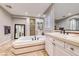 Luxurious bathroom with soaking tub, walk-in shower, and vanity at 61 Contrada Fiore Dr, Henderson, NV 89011