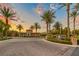 Gated entrance to community with palm trees and stonework at 61 Contrada Fiore Dr, Henderson, NV 89011