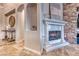 Elegant fireplace with stone surround and built-in shelving at 61 Contrada Fiore Dr, Henderson, NV 89011