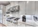 Modern kitchen with stainless steel appliances and white cabinetry at 61 Contrada Fiore Dr, Henderson, NV 89011