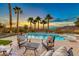 Luxury pool with patio furniture, offering stunning sunset views at 61 Contrada Fiore Dr, Henderson, NV 89011