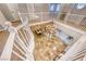 Elegant upstairs hall with a chandelier and stone feature wall at 61 Contrada Fiore Dr, Henderson, NV 89011