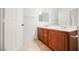 Bathroom with double vanity and wood cabinets at 7332 Marble Lake St # 103, Las Vegas, NV 89149