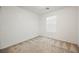 Simple bedroom with window and neutral carpet at 7332 Marble Lake St # 103, Las Vegas, NV 89149