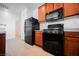 Modern kitchen featuring black appliances and wood cabinets at 7332 Marble Lake St # 103, Las Vegas, NV 89149