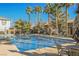 Community pool with palm trees and seating at 7332 Marble Lake St # 103, Las Vegas, NV 89149