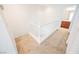 Upstairs hallway with carpet flooring and white railing at 7332 Marble Lake St # 103, Las Vegas, NV 89149