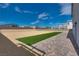 Landscaped backyard with artificial turf and paver patio at 8541 S Pioneer Way, Las Vegas, NV 89113