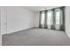 Bright bedroom with grey carpet and large windows at 8541 S Pioneer Way, Las Vegas, NV 89113