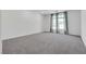 Bright bedroom with gray carpeting and large windows at 8541 S Pioneer Way, Las Vegas, NV 89113