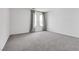 Bright bedroom with grey carpet and large windows at 8541 S Pioneer Way, Las Vegas, NV 89113