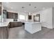 Modern kitchen with island, stainless steel appliances, and dark wood cabinets at 8541 S Pioneer Way, Las Vegas, NV 89113