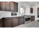 Kitchen boasts stainless steel appliances and dark wood cabinets at 8541 S Pioneer Way, Las Vegas, NV 89113