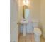 Clean and simple bathroom with pedestal sink and toilet at 8557 Nature Scene Dr, Las Vegas, NV 89139