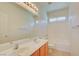 Clean bathroom with double vanity, bathtub, and tile floor at 8557 Nature Scene Dr, Las Vegas, NV 89139