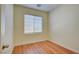 Simple bedroom with wood-look floors and a window at 8557 Nature Scene Dr, Las Vegas, NV 89139