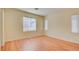 Simple bedroom with wood floors and multiple windows at 8557 Nature Scene Dr, Las Vegas, NV 89139