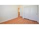 Simple bedroom with wood-look floors and access to another room at 8557 Nature Scene Dr, Las Vegas, NV 89139