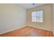 Bright bedroom with wood-look floors and a window at 8557 Nature Scene Dr, Las Vegas, NV 89139